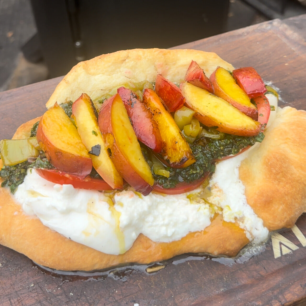 a pizza sandwich made with grilled nectarines and plums, fresh burrata and gremolata
