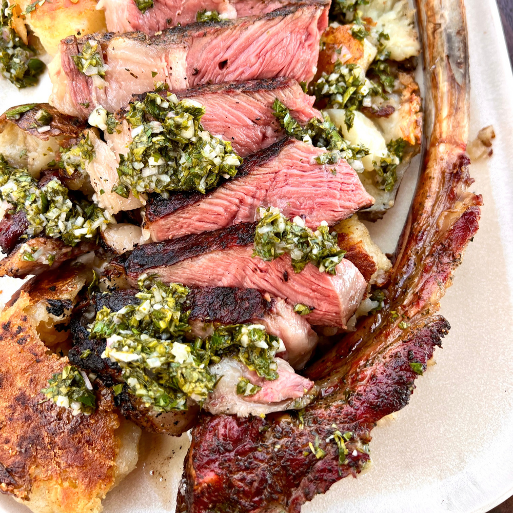 smoked and seared Tomahawk steak with smashed potatoes and chimichurri