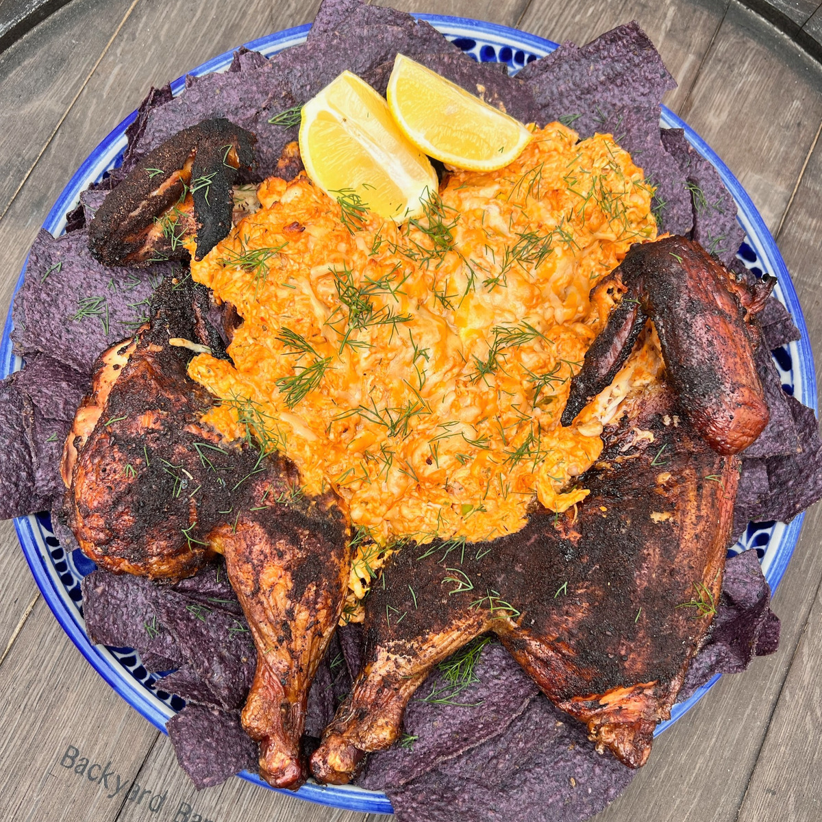 smoked chicken stuffed with buffalo chicken dip on a bed of blue corn tortillas