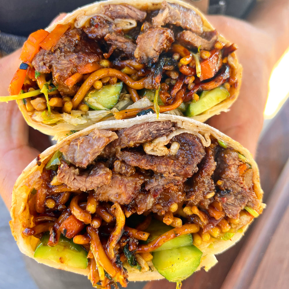 crispy beef burrito with chow mein noodles and grilled vegetables