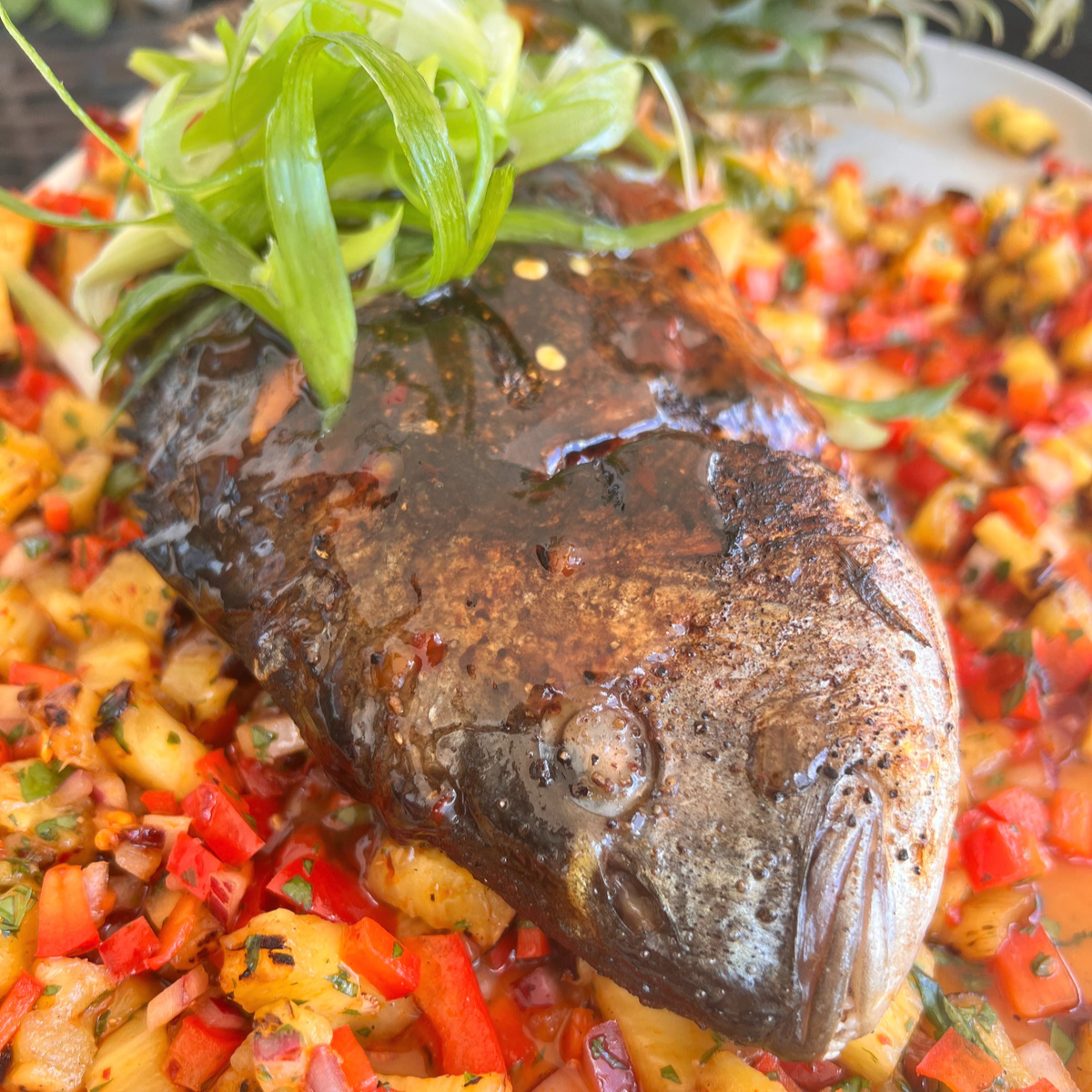 grilled whole seam bream with sweet chili heat sauce and pineapple salad