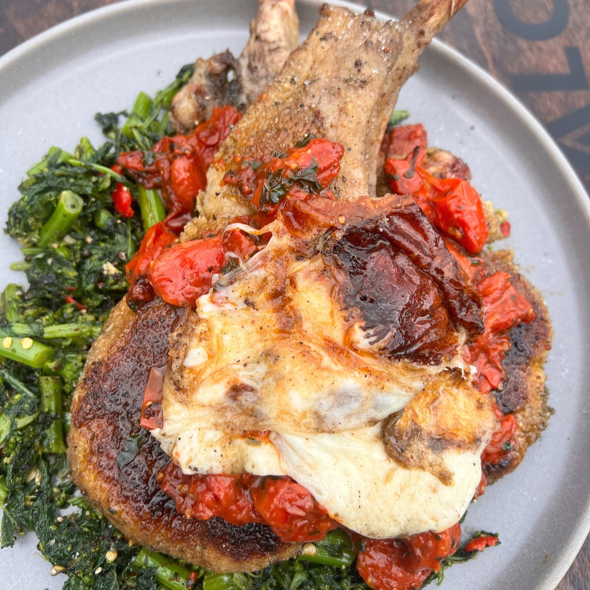 smoked pork chop milanese with chili-garlic rapini and grilled mozzarella