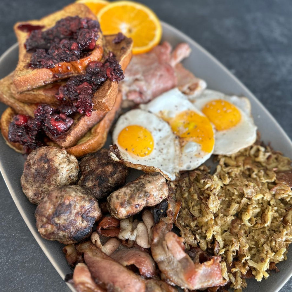 grand slam breakfast with bacon, eggs, peameal bacon, sausage, French toast with raspberry jam and hash browns