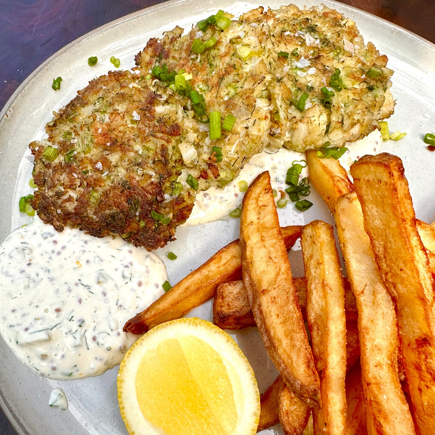 stone crab cakes made on the plancha with fries and tartar sauce