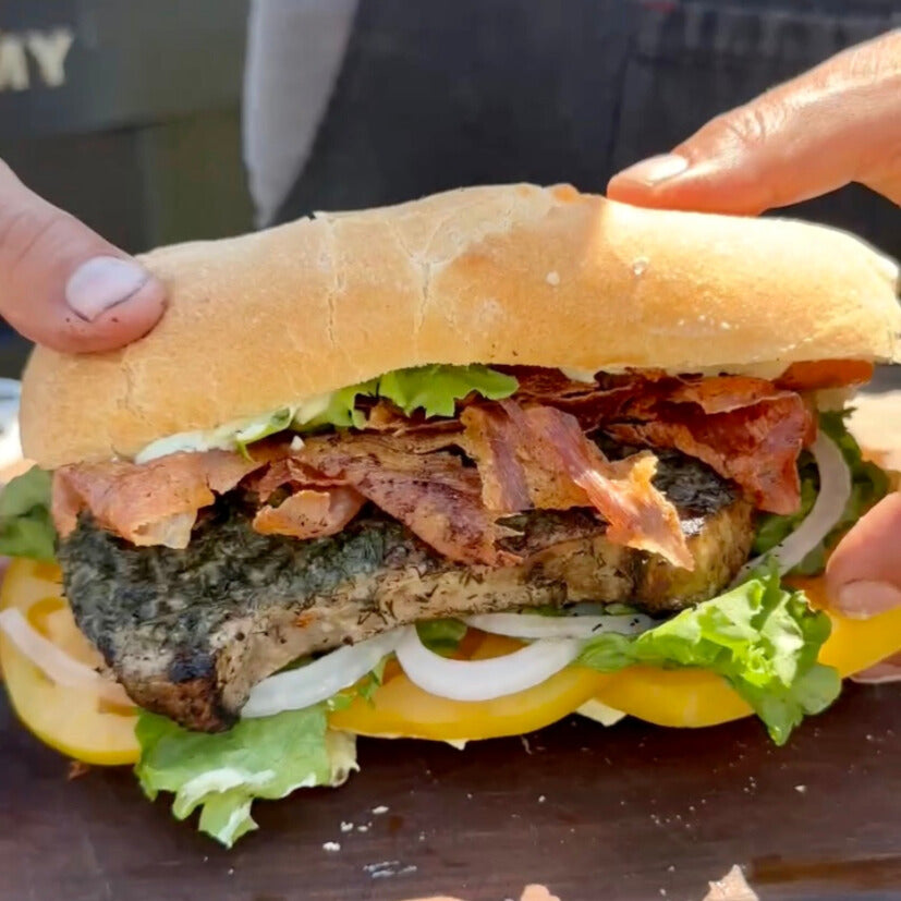 grilled swordfish sandwich with crispy prosciutto, heirloom tomato, onions and lettuce