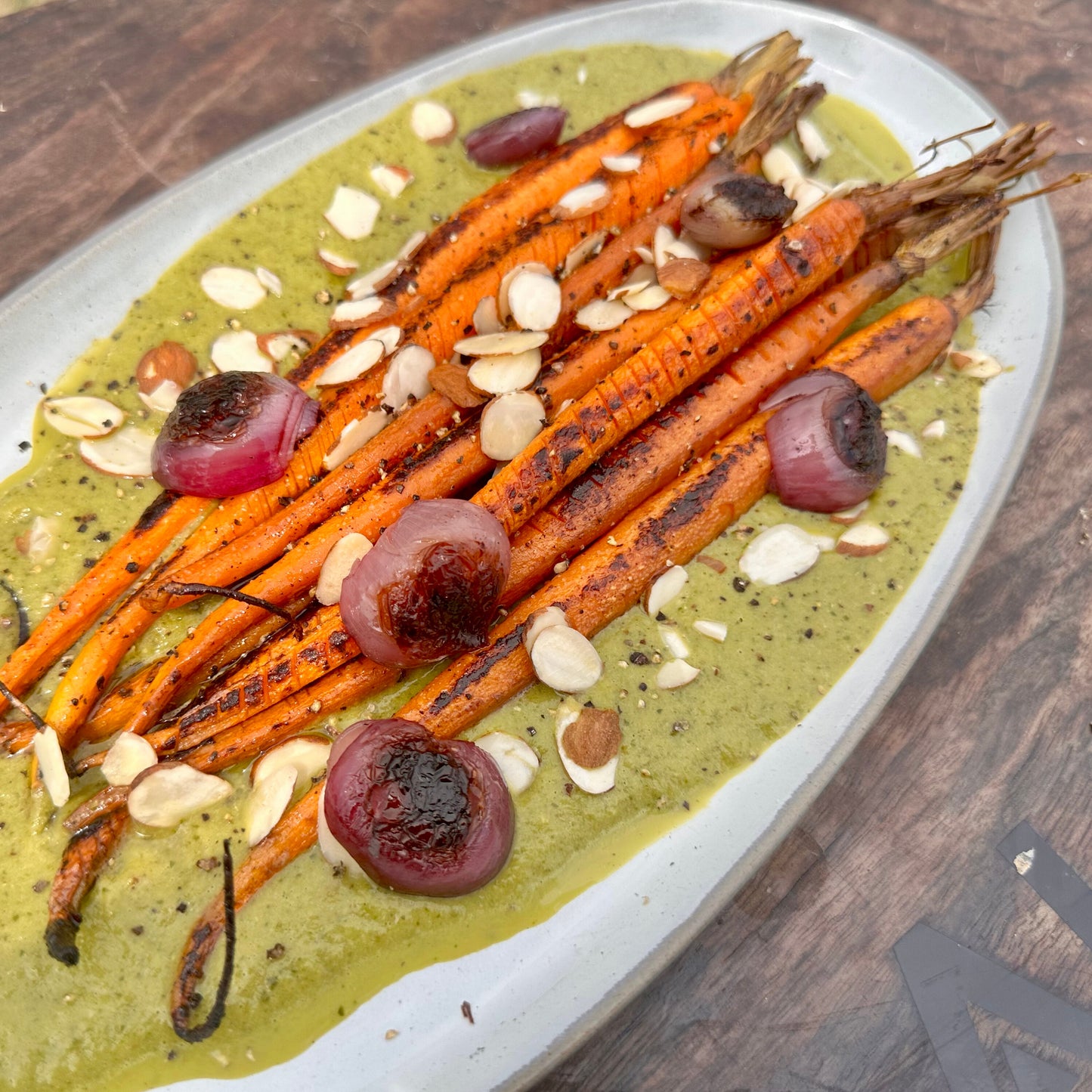 smoked hasselback carrots with salsa verde, sliced almonds and grilled shallots