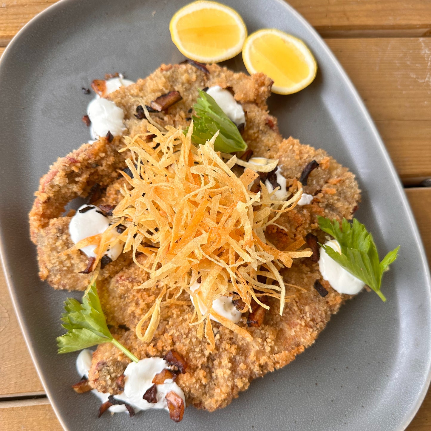 pork schnitzel with matchstick fries, grilled apple and sour cream