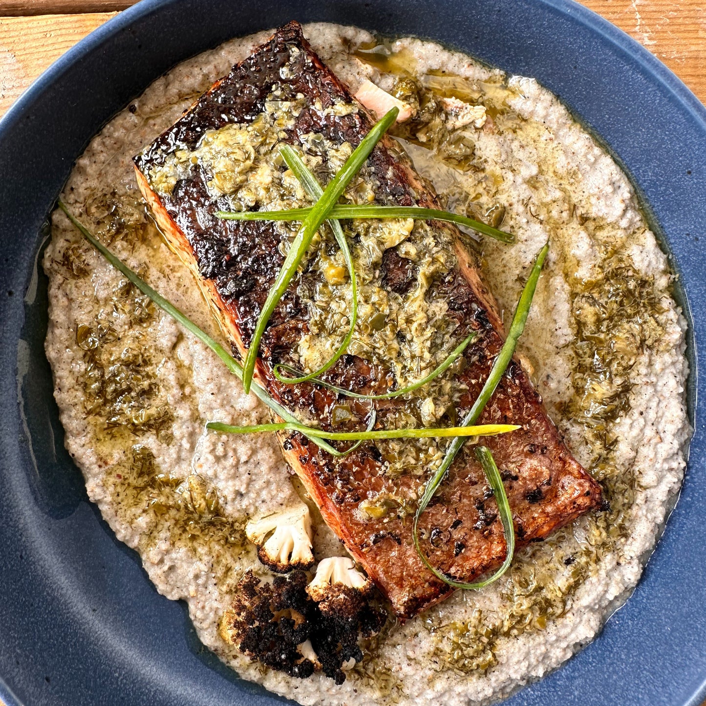 smoked cedar plank salmon with lemon caper butter and charred cauliflower purée