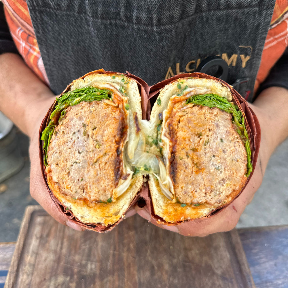a meatball sub sandwich cut in half looking at the midsection