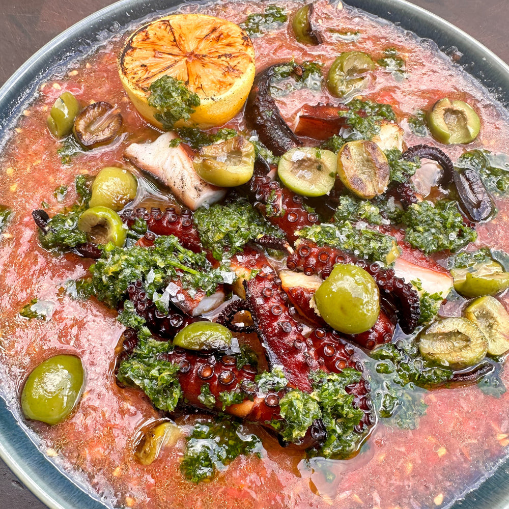 smoked and grilled octopus with olives and Spanish-style tomato